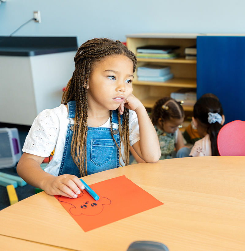 Young girl stops colouring due to having an absence seizure