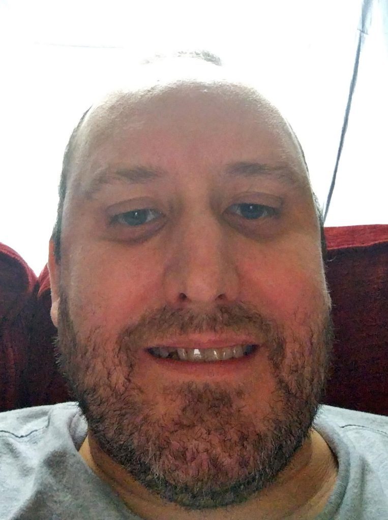 Photo of EA befriender Chris, smiling.