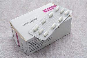A box of generic gabapentin tablets and a pack of tablets on top of it